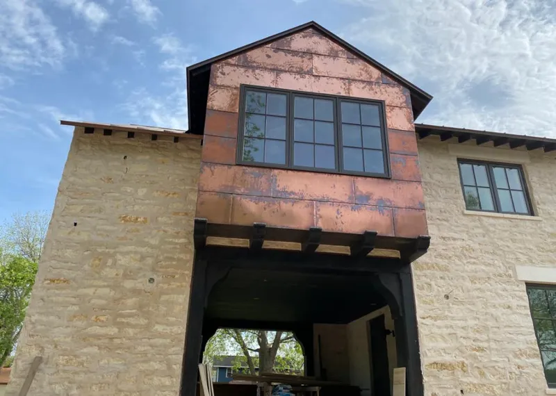 Copper metal panel facade on a stone building for Metal Roof Coating in Redmond