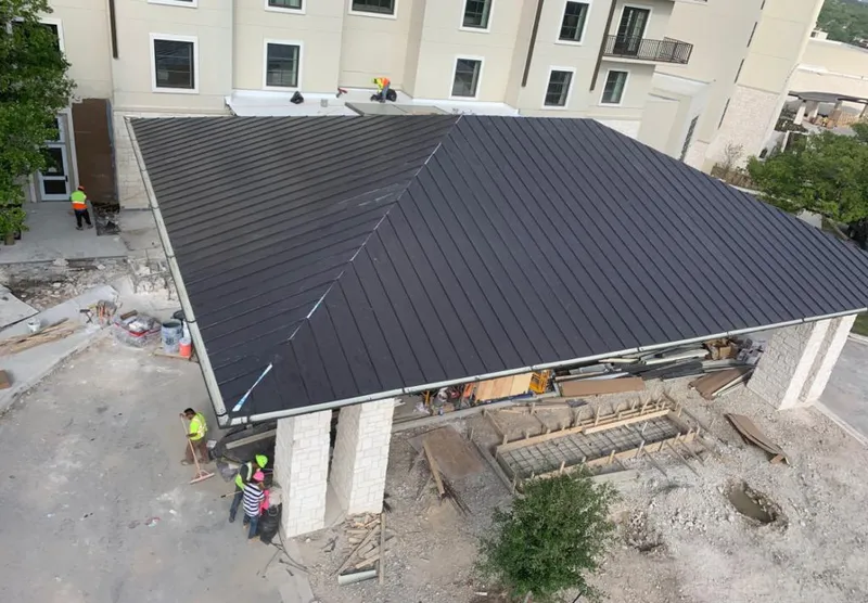 Metal roofing installation team working on a commercial building in Redmond